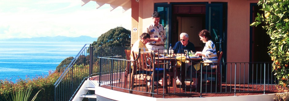 Guests dining on the deck at The Haven overlooking the ocean