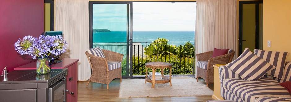 Lounge at The Haven with ocean views through sliding doors