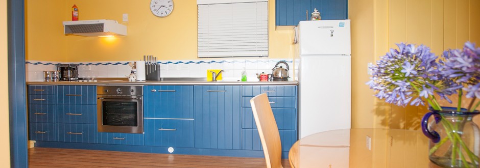 Kitchen area at The Haven with blue cabinetry