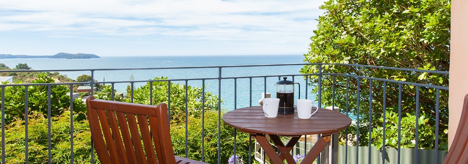 Small deck at The Haven with coffee cups and sea view