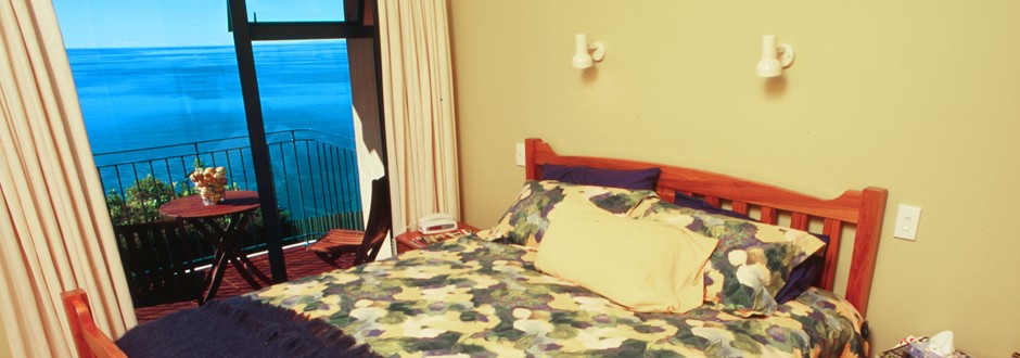 Master bedroom at The Haven with balcony and sea view