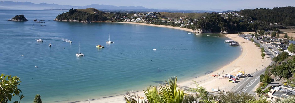 Wide view of Kaiteriteri Bay with boats and sandy shoreline